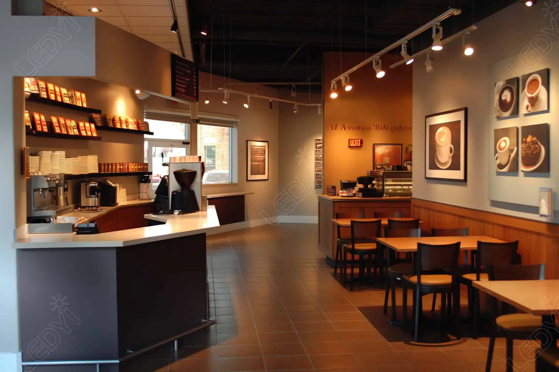 Cozy coffee shop interior with tables and counter.