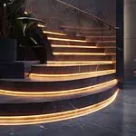 Illuminated modern staircase with LED strip lighting.